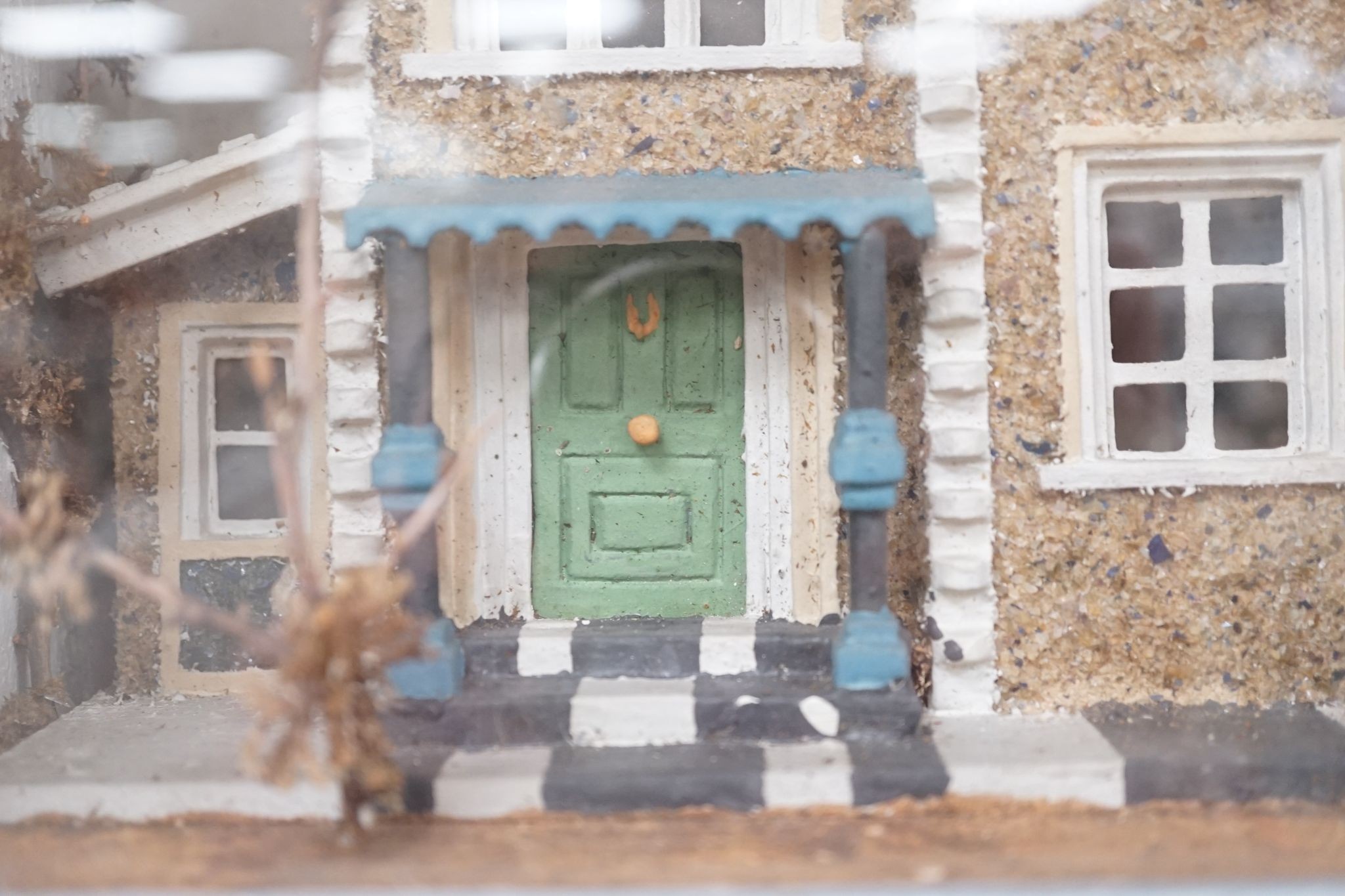 A diorama of a country house, case 63 cm wide